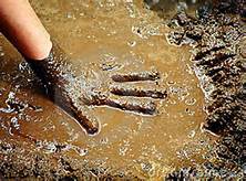 Child's hand in mud